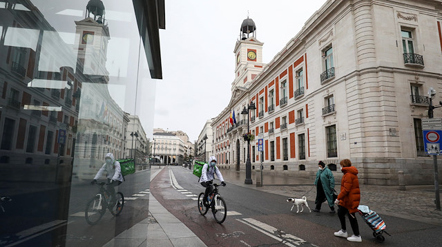 File photo: People wearing protective face masks are seen in an almost empty Puerta del Sol during a partial lockdown, which is a part of a 15-day state of emergency to combat the coronavirus disease (COVID-19) outbreak in Madrid, Spain, March 21, 2020