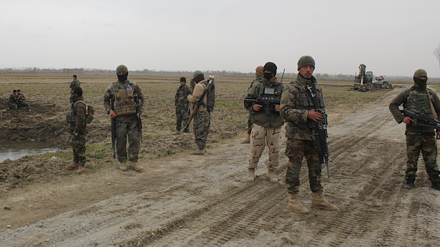 Afghan National Army (ANA) soldiers arrive at the site of last night clashes