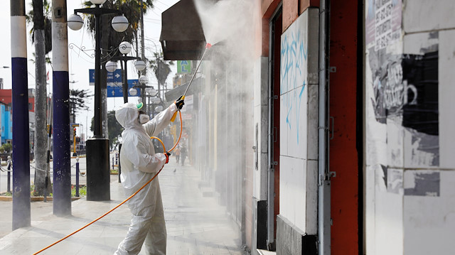 File photo: A municipal worker cleans the streets and facades in the Chorrillos neighborhood as Peru's government considers extending the days of the state of emergency and curfew to stop the spread of the coronavirus disease (COVID-19), in Lima, Peru March 21, 2020