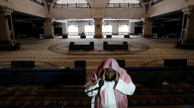 A cleric calls for the prayer at an empty Al-Rajhi Mosque, as Friday prayers were suspended following the spread of the coronavirus disease (COVID-19), in Riyadh, Saudi Arabia, March 20, 2020. REUTERS/Ahmed Yosri

