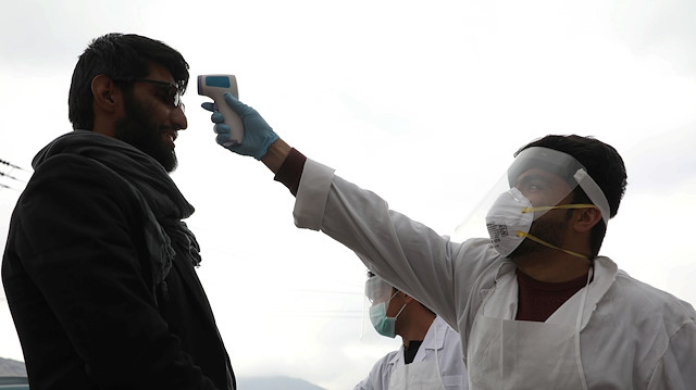 File photo: A medical official in protective gear checks the body temperature of a traveller, who arrives from provinces, amid concerns about the spread of coronavirus disease (COVID-19), in Kabul, Afghanistan March 24, 2020