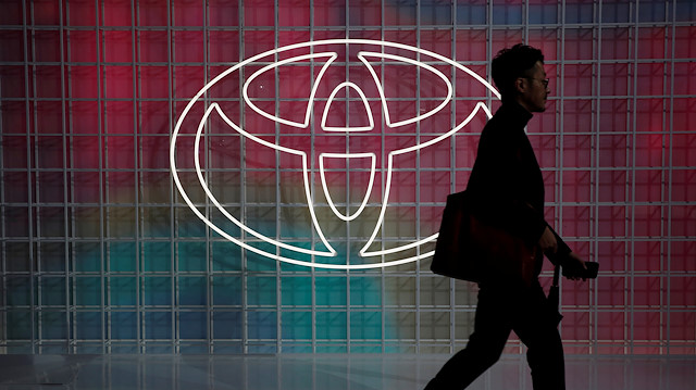 FILE PHOTO: A man walks past a Toyota logo at the Tokyo Motor Show, in Tokyo, Japan October 24, 2019