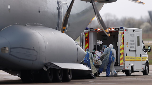 A patient, infected with coronavirus disease (COVID-19), is carried on a stretcher into a German military A400M aircraft during a transfer operation from Strasbourg to Ulm in Germany, France March 29, 2020. REUTERS/Christian Hartmann

