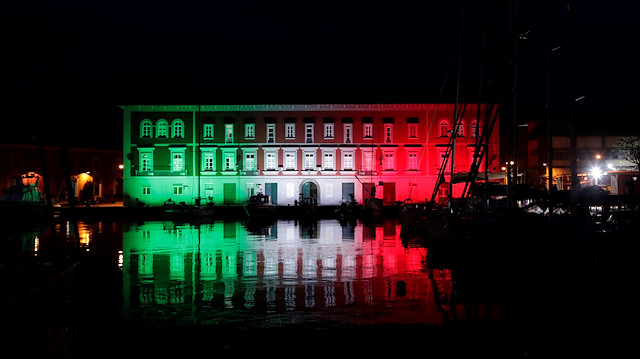 The Navy base is seen illuminated with the colours of the Italian flag, as Italy struggles to contain the spread of coronavirus disease (COVID-19), in Naples, Italy March 29, 2020