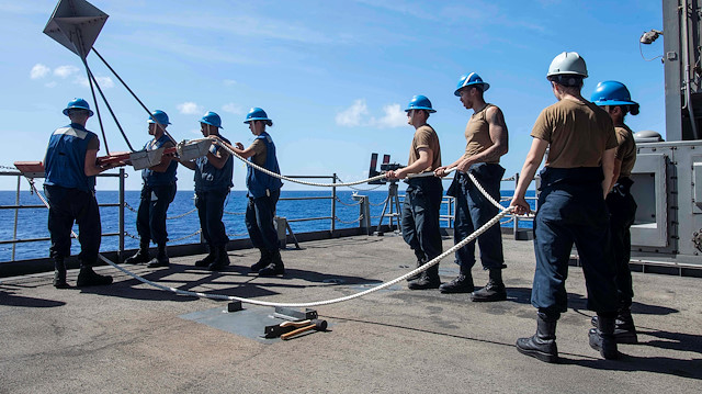 File photo: U.S. Navy sailors lower a larne target from the fantail of the aircraft carrier USS Theodore Roosevelt in the Philippine Sea March 21, 2020