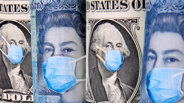 George Washington and Queen Elizabeth II are seen with printed medical masks on the one Dollar and Pound banknotes in this illustration taken, March 31, 2020. REUTERS/Dado Ruvic/Illustration

