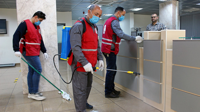FILE PHOTO: Members of Red Crescent spray disinfectants, as part of precautionary measures against coronavirus disease (COVID-19) at government offices in Misrata, Libya March 21, 2020.