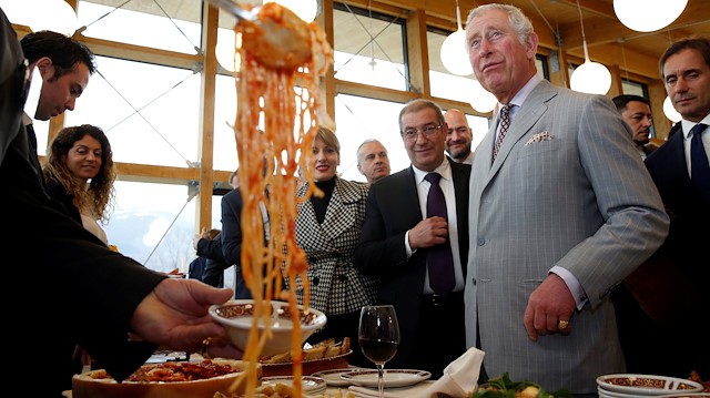 Britain's Prince Charles is offered Amatriciana pasta dish during his visit to the town of Amatrice, which was levelled after an earthquake last year, in central Italy April 2, 2017. REUTERS/Alessandro Bianchi TPX IMAGES OF THE DAY

