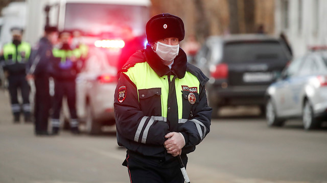 A Russian traffic police officer wearing a protective mask
