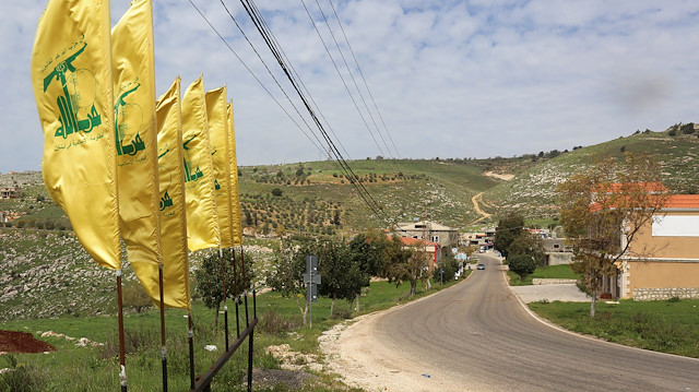 Hezbollah flags flutter along an empty street