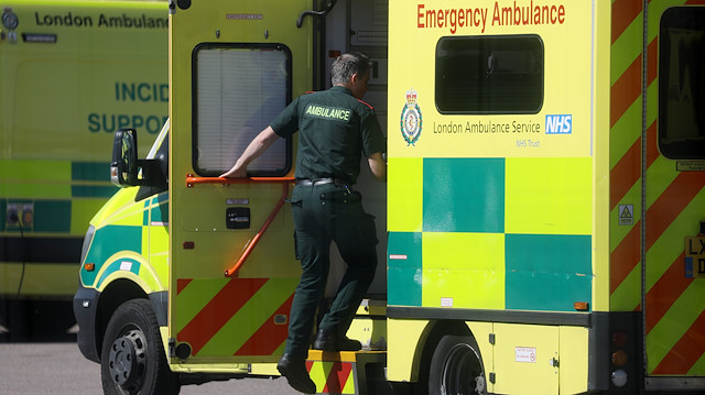 Paramedics and a ambulance is seen outside NHS Nightingale Hospital