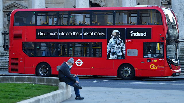 A bus is seen as a man wearing a mask sits down, as the spread of the coronavirus disease 