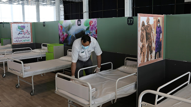 A medical aid worker sets up and installs a bed at a shopping mall