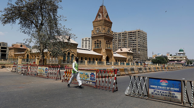 A traffic police officer walks past barriers used to block the road