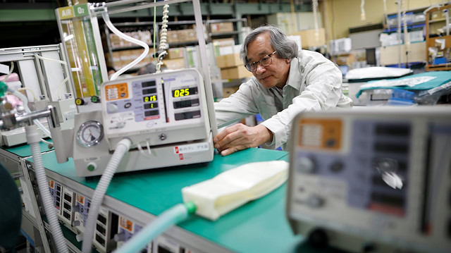 Metran Co. Chairman and CEO Kazufuku Nitta, who also uses the Vietnamese name Tran Ngoc Phuc, touches the company's 'Compos X' ventilator, which was originally developed for animals but may be used for human coronavirus disease (COVID-19) patients, at its factory in Kawaguchi, north of Tokyo, Japan April 2, 2020