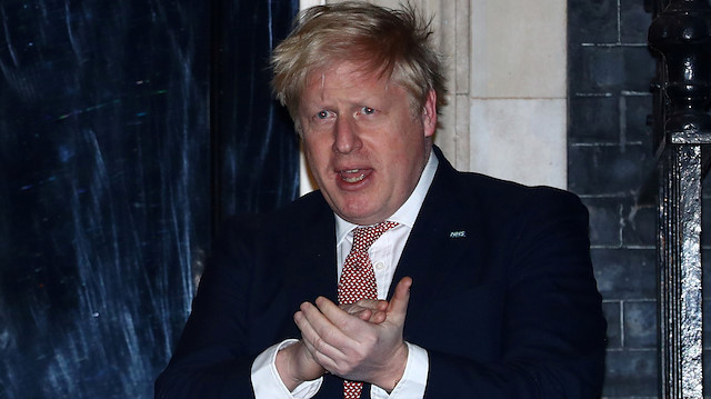 FILE PHOTO: Britain's Prime Minister Boris Johnson applauds outside 10 Downing Street during the Clap For Our Carers campaign in support of the NHS, as the spread of the coronavirus disease (COVID-19) continues, London, Britain, March 26, 2020