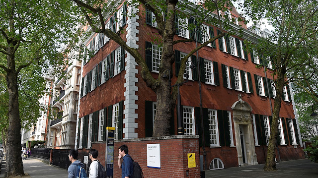 Students walk out of the campus of Imperial College London, Britain