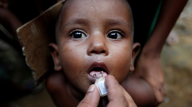 FILE PHOTO: A Rohingya refugee child gets an oral cholera vaccine, distributed by the World Health Organisation (WHO) with the help of volunteers and local NGO's, in a refugee camp near Cox's Bazar, Bangladesh October 11, 2017
