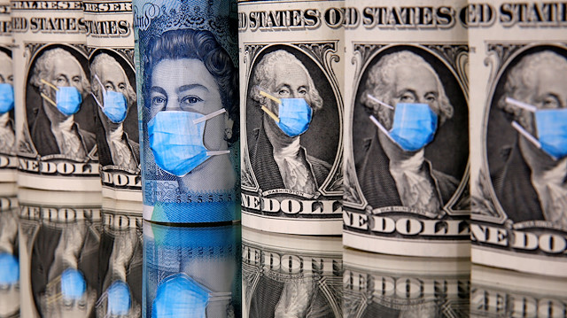 File photo: George Washington and Queen Elizabeth II are seen with printed medical masks on the one Dollar and Pound banknotes in this illustration taken, March 31, 2020