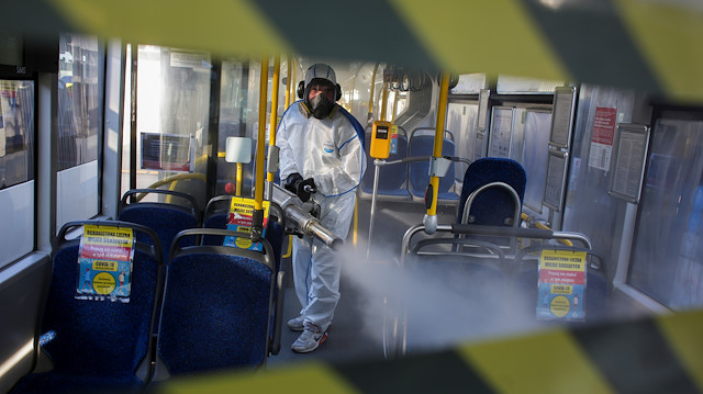 A worker wearing protective gear disinfects a public bus during the outbreak of the coronavirus disease (COVID-19) in Gdynia, Poland, April 5, 2020
