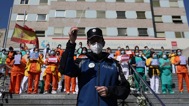 Members of the Municipal Police music band perform to honor health workers at Gregorio Maranon hospital during the lockdown amid the coronavirus disease (COVID-19) outbreak in Madrid, Spain, April 12, 2020. REUTERS/Susana Vera

