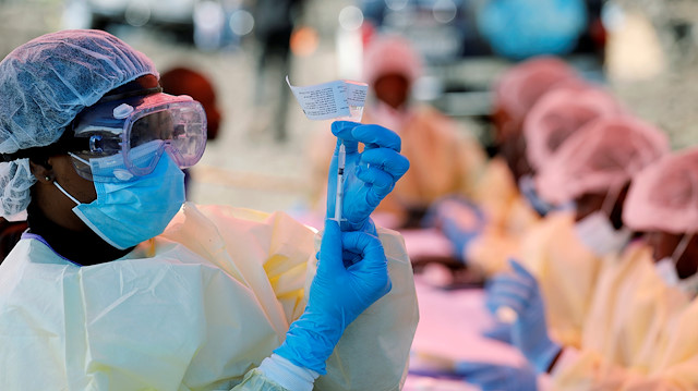 FILE PHOTO: A health worker fills a syringe with Ebola vaccine before injecting it to a patient, in Goma, Democratic Republic of Congo, August 5, 2019