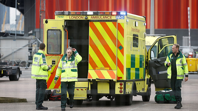 Paramedics and an ambulance are seen outside the Excel Centre, London