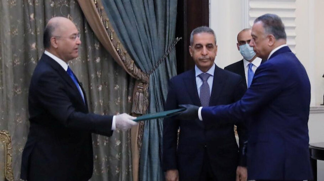 Iraq's President Barham Salih instrcuts newly appointed Prime Minister Mustafa al-Kadhimi in Baghdad, Iraq April 9, 2020.