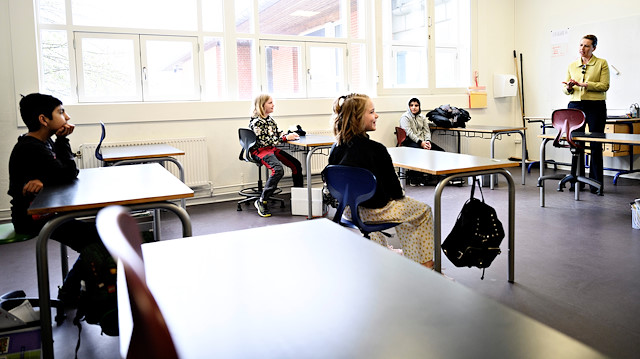Danish Prime Minister Mette Frederiksen speaks with pupils as she participates in the reopening of Lykkebo School in Valby, after its lockdown due to the coronavirus disease (COVID-19) spread, in Copenhagen, Denmark April 15, 2020. Ritzau Scanpix/Philip Davali via REUTERS 
