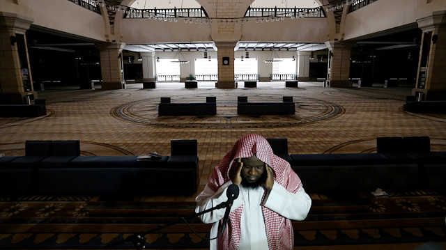FILE PHOTO: A cleric calls for the prayer at an empty Al-Rajhi Mosque, as Friday prayers were suspended following the spread of the coronavirus disease (COVID-19), in Riyadh, Saudi Arabia, March 20, 2020
