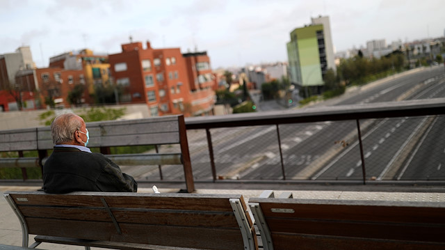 File photo: An elderly man wearing a protective masks rests on a bench in front of an empty Meridiana Avenue, during the coronavirus disease (COVID-19) outbreak, in Barcelona, Spain April 16, 2020