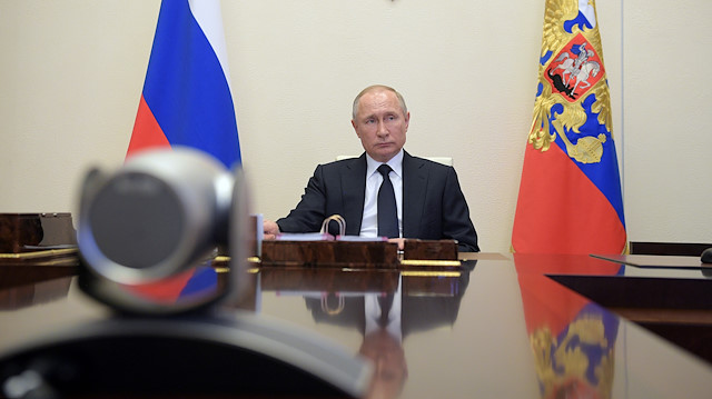 Russian President Vladimir Putin chairs a meeting with members of the government via video link at his residence outside Moscow, Russia April 15