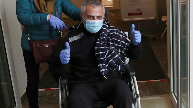 Belgian doctor Antoine Sassine, urologist at Chirec Delta Hospital, who survived the coronavirus (COVID-19) disease after 6 weeks in the intensive care unit and 3.5 weeks in a coma is helped by his wife Alexandra as he leaves the hospital in Brussels, Belgium, April 19, 2020. REUTERS/Yves Herman

