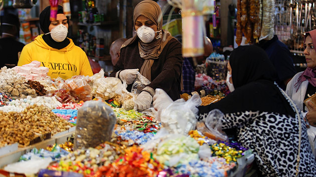 Women wear protective face masks while shopping after the lockdown measures following the outbreak of the coronavirus disease (COVID-19) were partially eased, to prepare for the holy month of Ramadan, in Baghdad, Iraq, April 21, 2020. REUTERS/Khalid al Mousily

