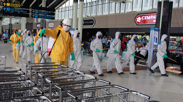 Airport officer sprays disinfectant at a Soekarno-Hatta International Airport, to prevent the spread of coronavirus disease (COVID-19), in Tangerang, near Jakarta, Indonesia March 25, 2020 