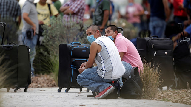 Migrants seeking for a U.S. work visa are seen waiting in a park of downtown of Monterrey, Mexico 