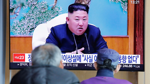 FILE PHOTO: South Korean people watch a TV broadcasting a news report on North Korean leader Kim Jong Un in Seoul, South Korea, April 21, 2020