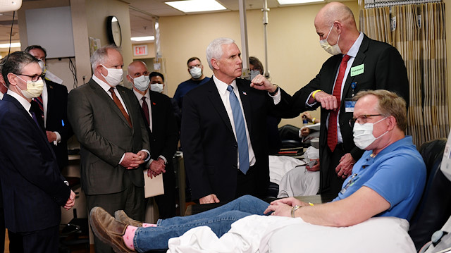 Vice President Mike Pence visits Dennis Nelson, a recovered COVID-19 disease patient who is now donating his blood for research on the virus and disease as Pence tours Mayo Clinic facilities supporting coronavirus disease (COVID-19) research and treatment in Rochester, Minnesota, U.S., April 28, 2020. REUTERS/Nicholas Pfosi TPX IMAGES OF THE DAY

