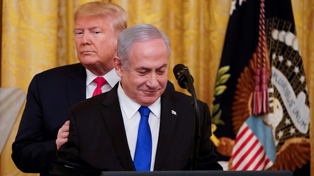 FILE PHOTO: U.S. President Donald Trump puts his hands on Israel's Prime Minister Benjamin Netanyahu's shoulders as they deliver joint remarks on a Middle East peace plan proposal in the East Room of the White House in Washington, U.S., January 28, 2020. REUTERS/Joshua Roberts/File Photo

