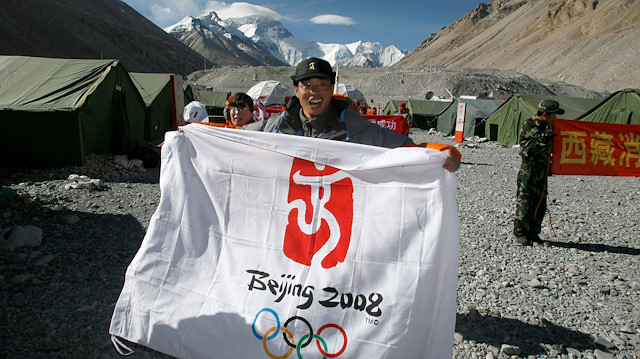 FILE PHOTO: ON THIS DAY -- May 8 May 8, 2008 OLYMPICS - A member of the support crew for the Beijing Olympics torch relay team celebrates at Everest Base Camp after climbers reach the summit of the world's highest mountain. Five climbers from the 31-strong team go to top of the mountain where they unfurled a Chinese and Olympic flag as well as a Beijing Games banner, fulfilling their government's goal of having the Olympic flame lit on top of Mt Everest. REUTERS/David Gray/File photo

