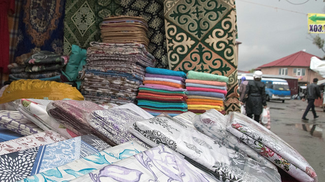 Towels and bed linen produced in Turkmenistan are displayed for sale at a market in Almaty