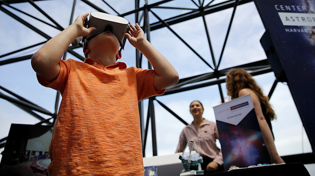 Cooper McDonough, an 8-year old boy from Scituate, MA, wears virtual reality goggles during the JFK Space Summit, celebrating the 50th anniversary of the moon landing, at the John F. Kennedy Library in Boston, Massachusetts, U.S., June 19, 2019. REUTERS/Katherine Taylor

