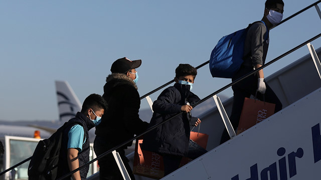 File photo: Unaccompanied children from overcrowded migrant camps who will be transferred to Germany, wear protective face masks as a precaution against the spread of coronavirus disease (COVID-19) as they board their flight at the Athens International Airport, Greece, April 18, 2020