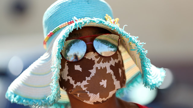 A woman wears a protective face mask during food distribution, as South Africa starts to relax some aspects of a stringent nationwide coronavirus disease (COVID-19) lockdown, in Diepsloot near Johannesburg, South Africa, May 8, 2020. REUTERS/Siphiwe Sibeko TPX IMAGES OF THE DAY

