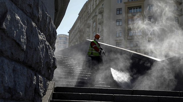 A specialist sprays disinfectant while sanitizing a bridge amid the outbreak of the coronavirus 