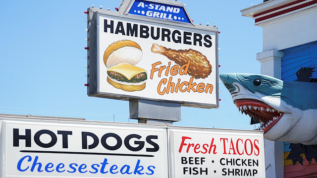 Fast food signs against a clear blue sky are seen on the first day coronavirus disease (COVID-19) restrictions were eased in Ocean City, Maryland, U.S., May 9, 2020. REUTERS/Kevin Lamarque

