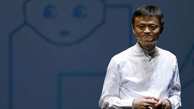 FILE PHOTO - Jack Ma, founder and executive chairman of China's Alibaba Group, speaks in front of a picture of SoftBank's human-like robot named 'pepper' during a news conference in Chiba, Japan, June 18, 2015. 