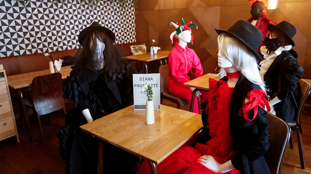 Mannequins dressed in creations of local designer sit at the table in a restaurant during the coronavirus disease (COVID-19) outbreak in Vilnius, Lithuania May 21, 2020. REUTERS/Ints Kalnins

