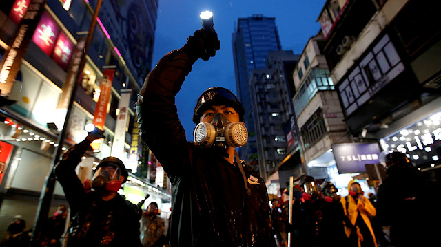 FILE PHOTO: Demonstrators protesting the proposed extradition bill aim their flashlights towards riot police as they are chased through the streets of Hong Kong, China, August 25, 2019. Reuters has been awarded the 2020 Pulitzer Prize in Breaking News Photography for Hong Kong protests. 