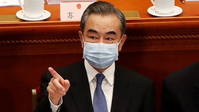 Chinese Foreign Minister Wang Yi wearing a face mask following the coronavirus disease (COVID-19) outbreak attends the opening session of the National People's Congress (NPC) at the Great Hall of the People in Beijing, China May 22, 2020. REUTERS/Carlos Garcia Rawlins

